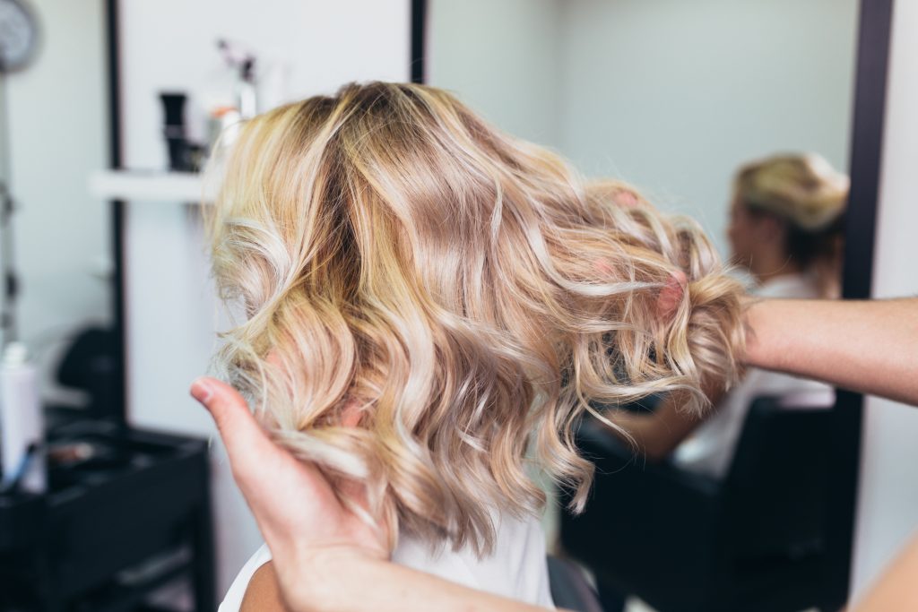 balayage blonde and strawberry pink tones done by hairdresser